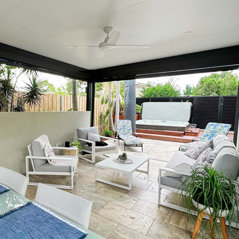 Luxurious outdoor area featuring an insulated patio awning with Versiclad roofing, ceiling fan, and modern furnishings by Sydney Patios